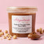 Vasetto di pasta di nocciola italiana pura 100% da 250g su sfondo rosa, con nocciole intere e cucchiaio.