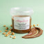 Vasetto di pasta di nocciola pura italiana 250g con nocciole intere e crema sullo sfondo verde, ideale per dolci e pasticceria.